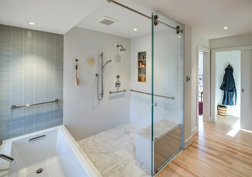 Universal design bathroom with curbless shower, bench, and grab bars