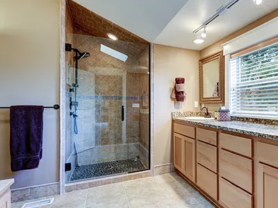 A glass shower with wood cabinets without hardware
