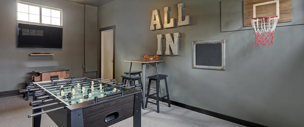 Man cave with gray walls and small football table