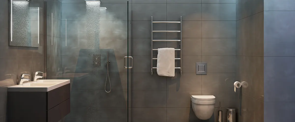 Modern bathroom with black tiling and walk-in shower