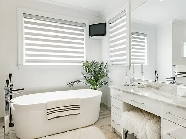 A tub with a simple vanity and windows