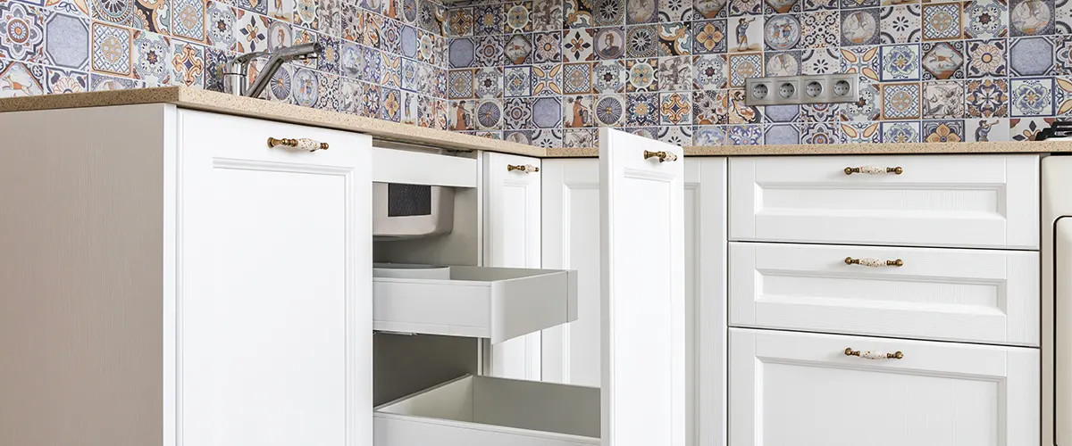 A close up with open drawers on a white cabinet