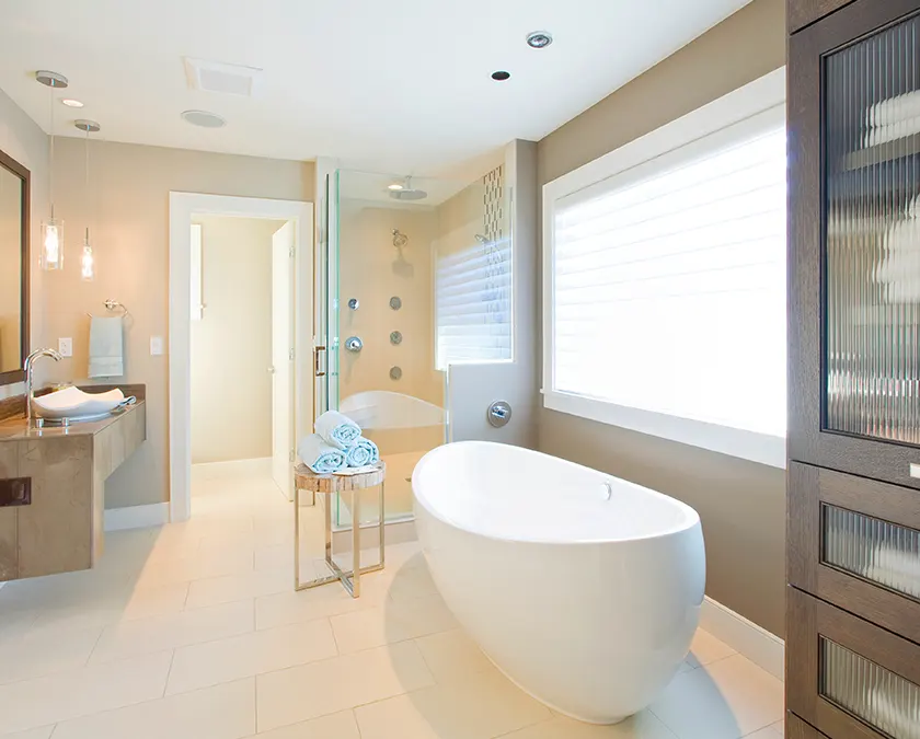 A bathroom with a freestanding tub and a glass shower