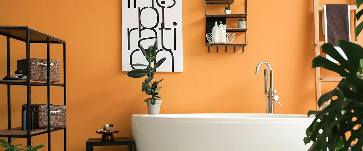 A white tub with orange walls, plants, and shelves