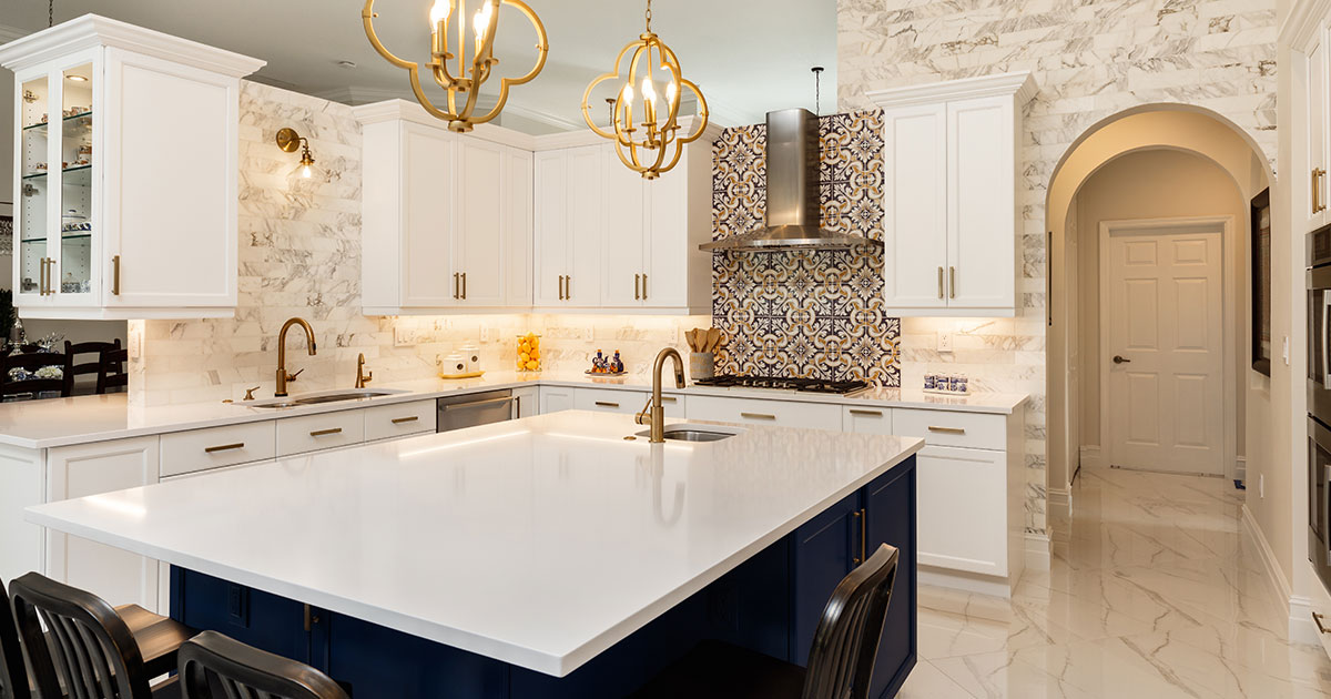 A marble countertops with blue island and white cabinets