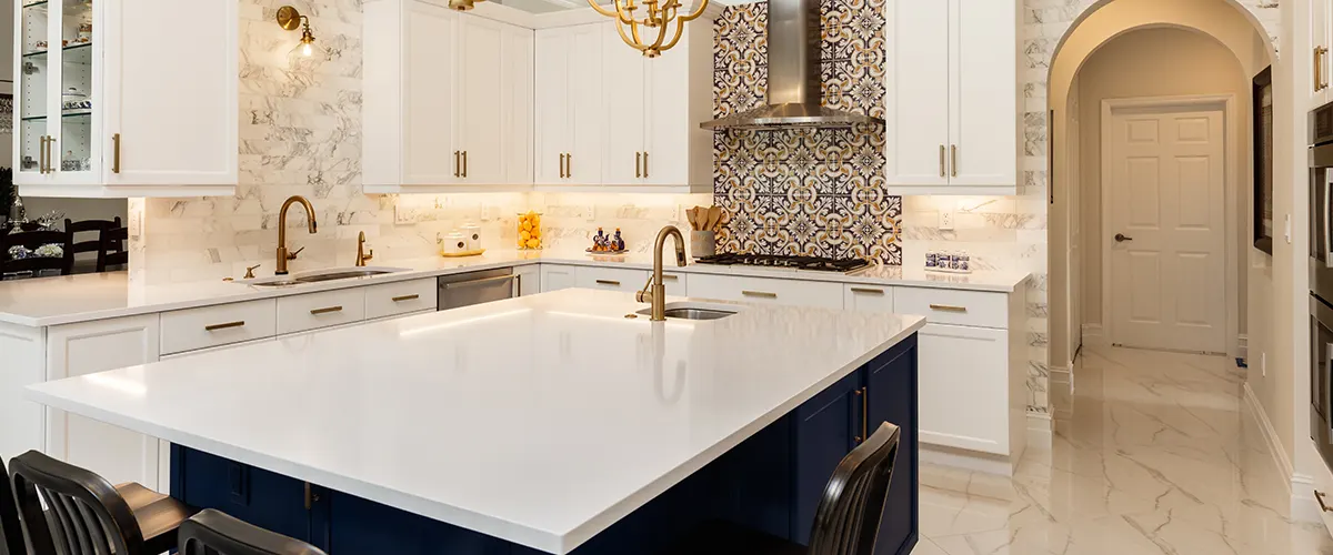 Marble countertop with dark blue cabinets and golden faucet
