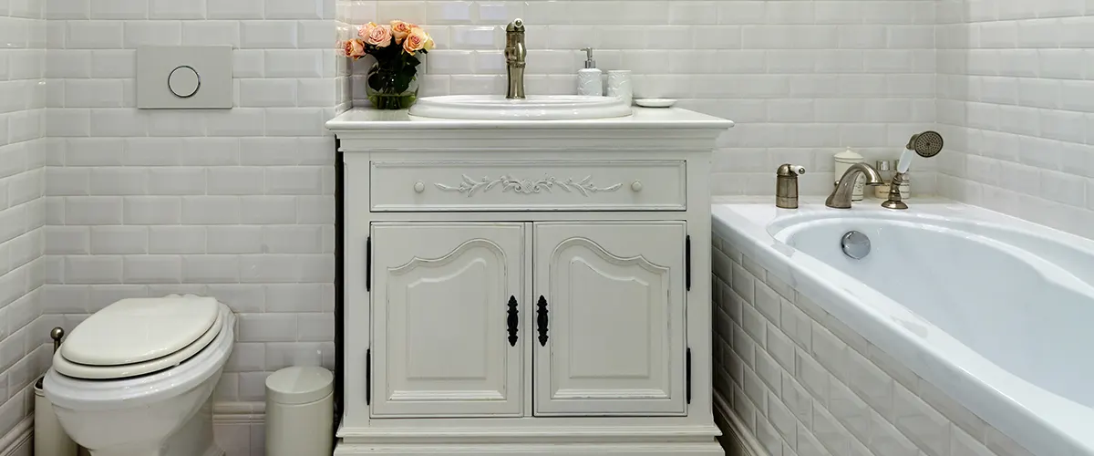 White bathroom vanity with dark hardware