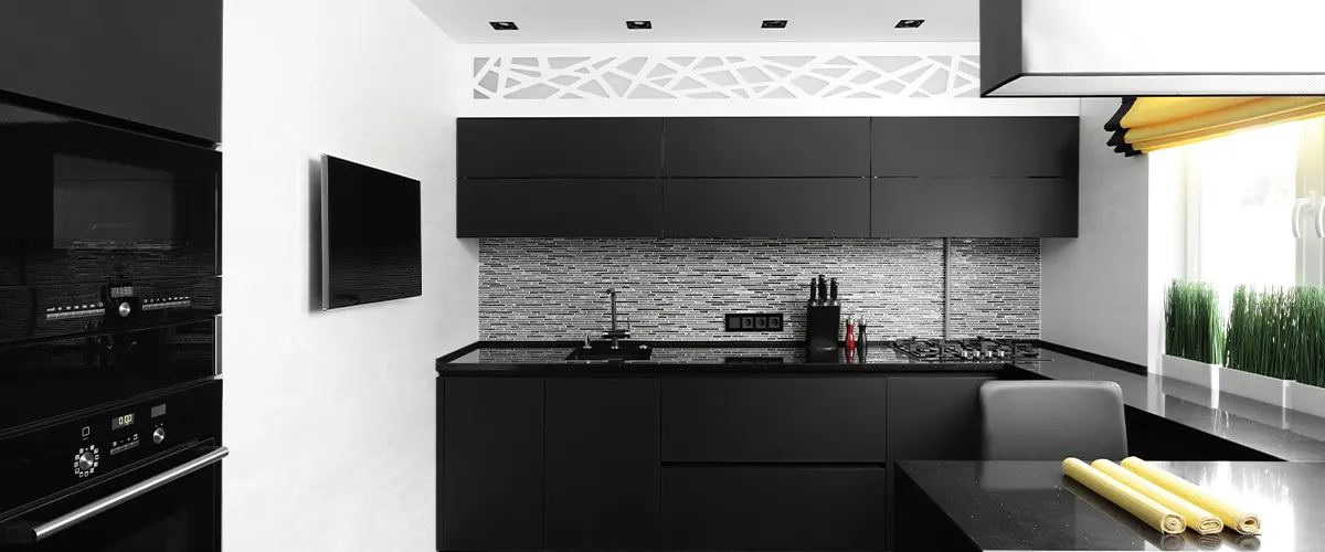 A modern kitchen with black kitchen cabinets in slab style