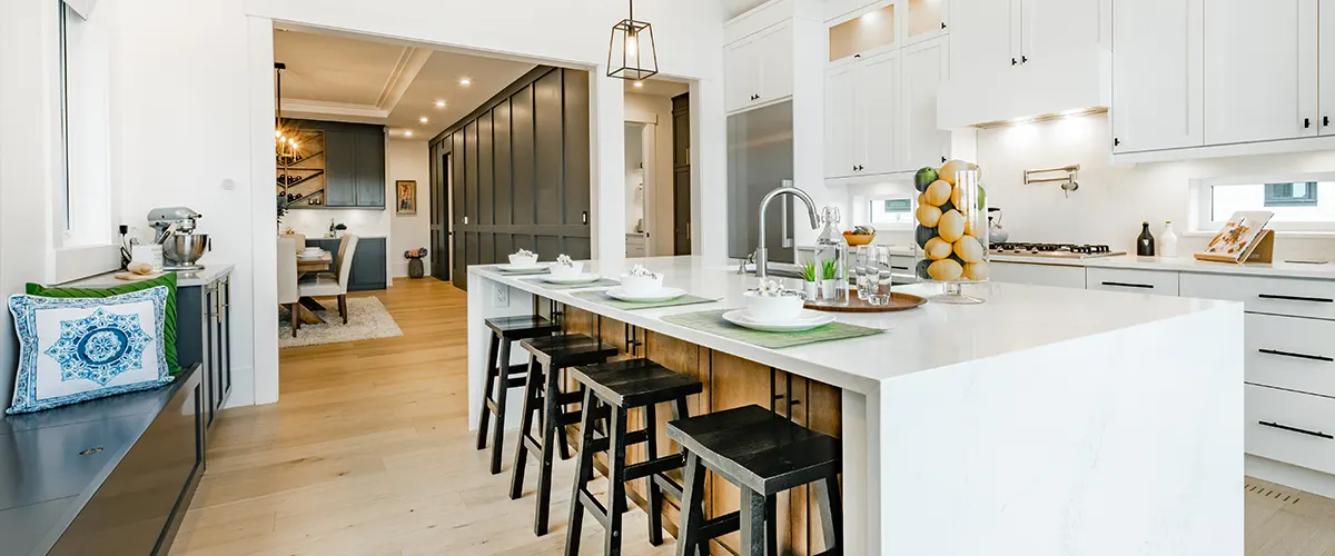A kitchen island with wooden stools