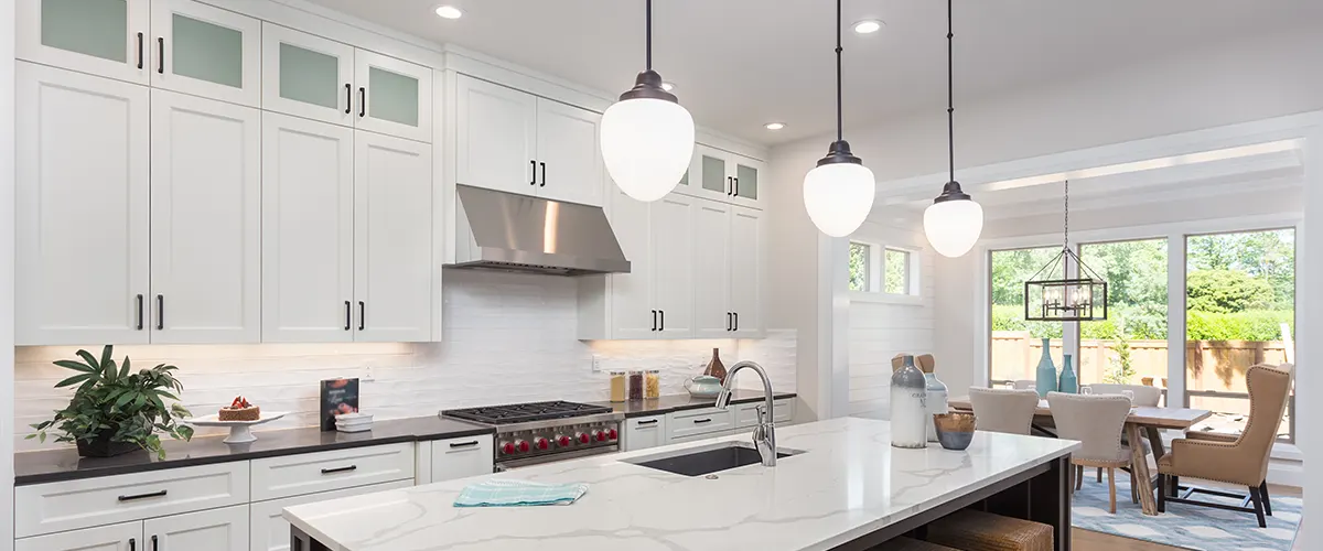 Lighting options in a kitchen with white cabinets