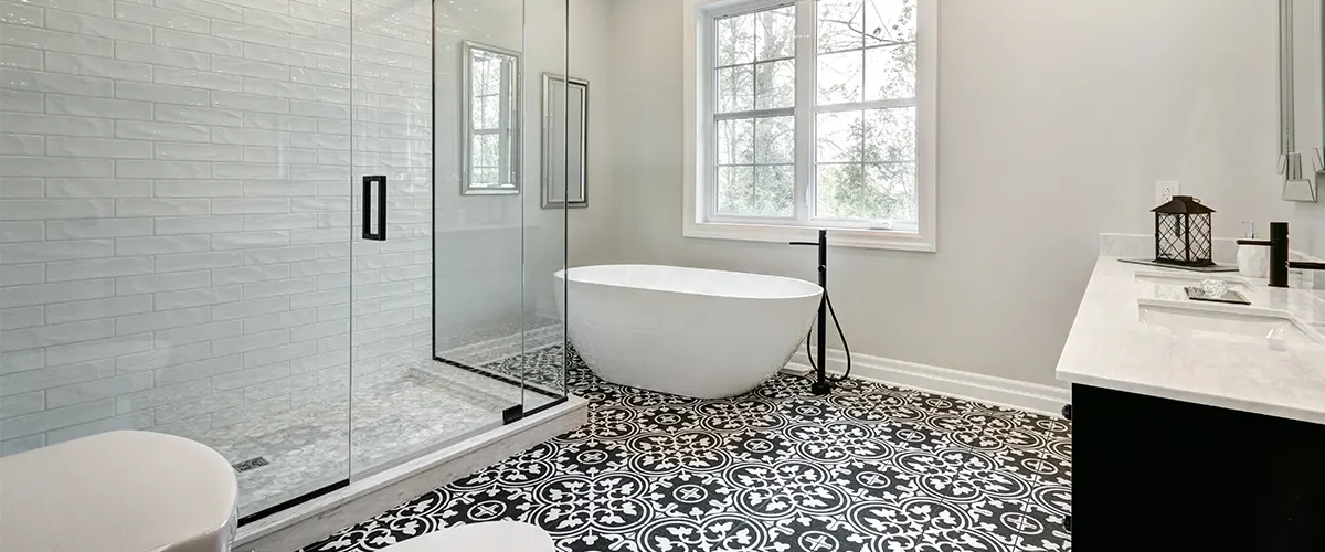 White bathroom remodel in Johnson County with dark decorative tile flooring