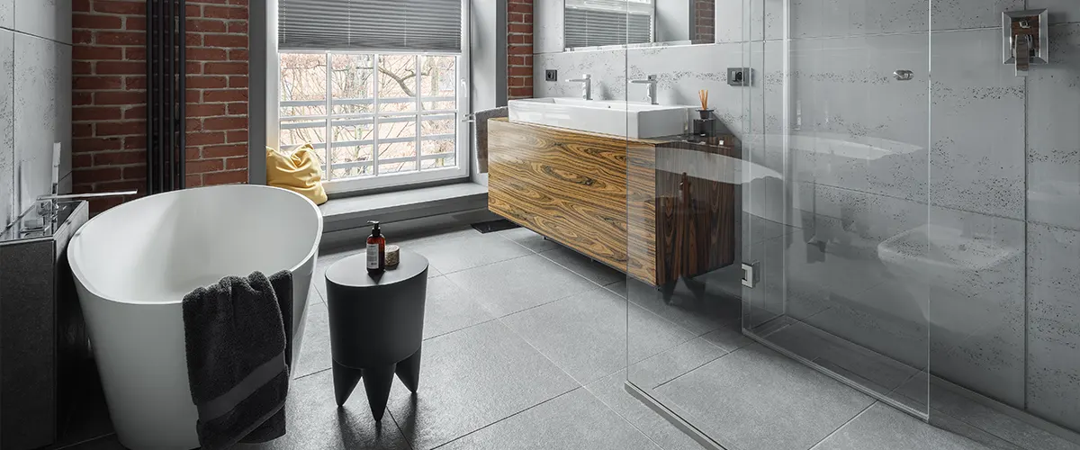 A modern bathroom with brick wall and a freestanding tub