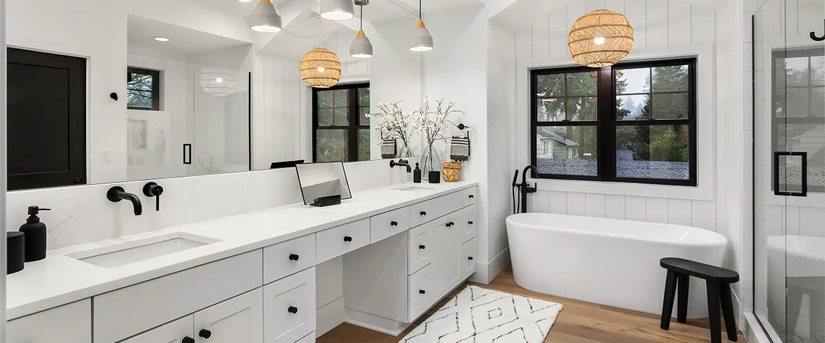 A marble countertop with white cabinets and dark hardware
