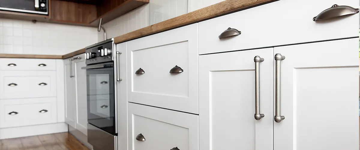 Semi-custom cabinets painted white with silver hardware