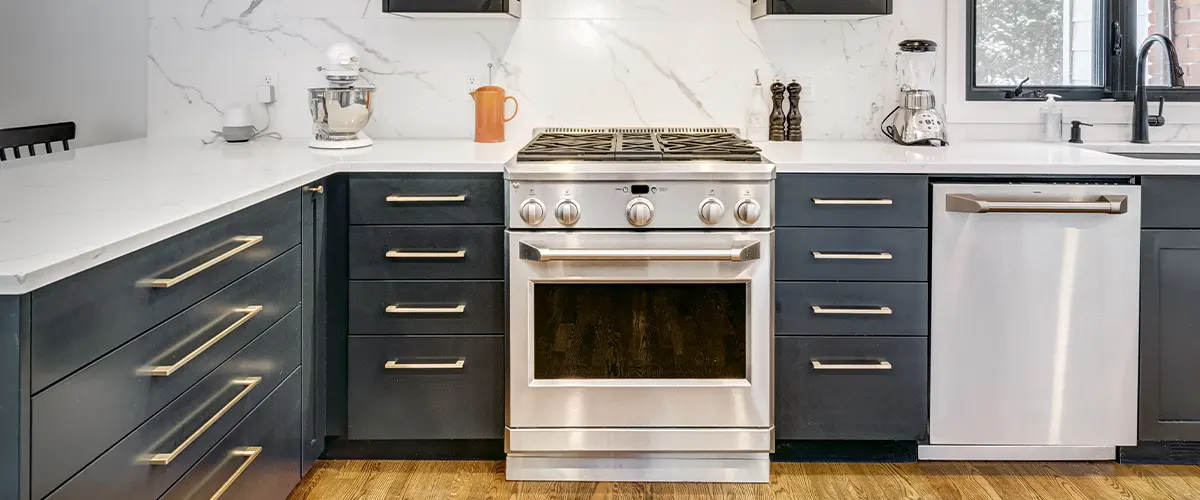 Dark blue kitchen cabinets with a kitchen range and a dishwasher