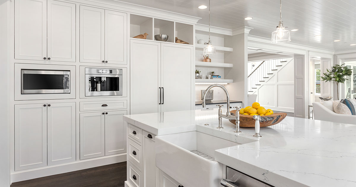 Refinishing kitchen cabinets with white paint and silver and black hardware