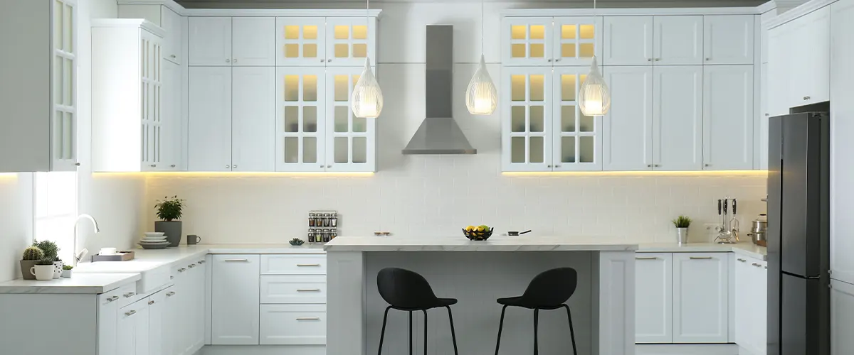 White transitional kitchen cabinets with dark stools