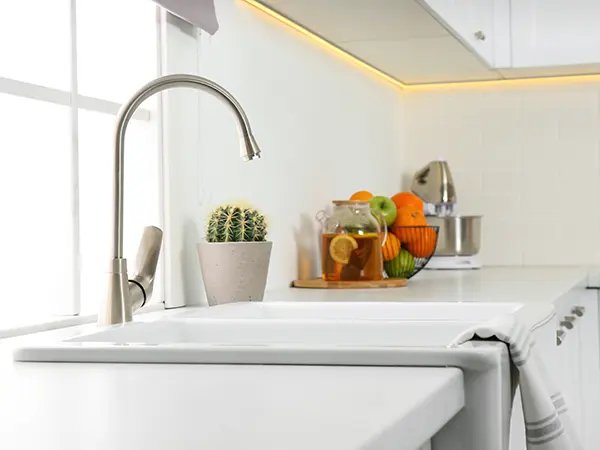 An undermount sink with a silver faucet