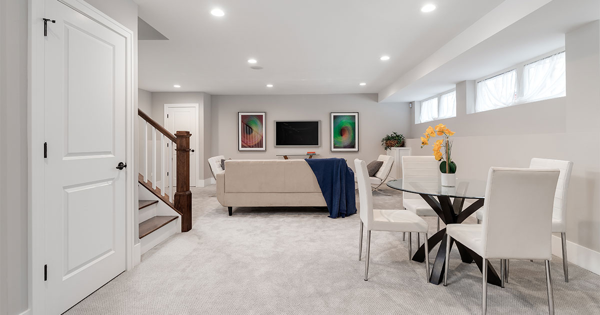 White basement with carpet floor and furniture