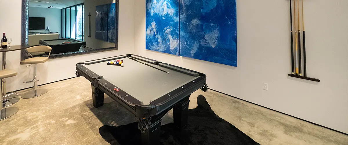 A pool table with a large painting