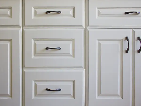 White kitchen cabinets with dark pulls