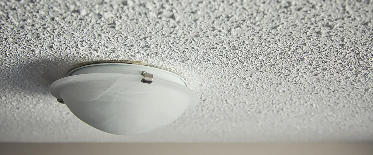 Popcorn ceiling with traditional lighting fixture
