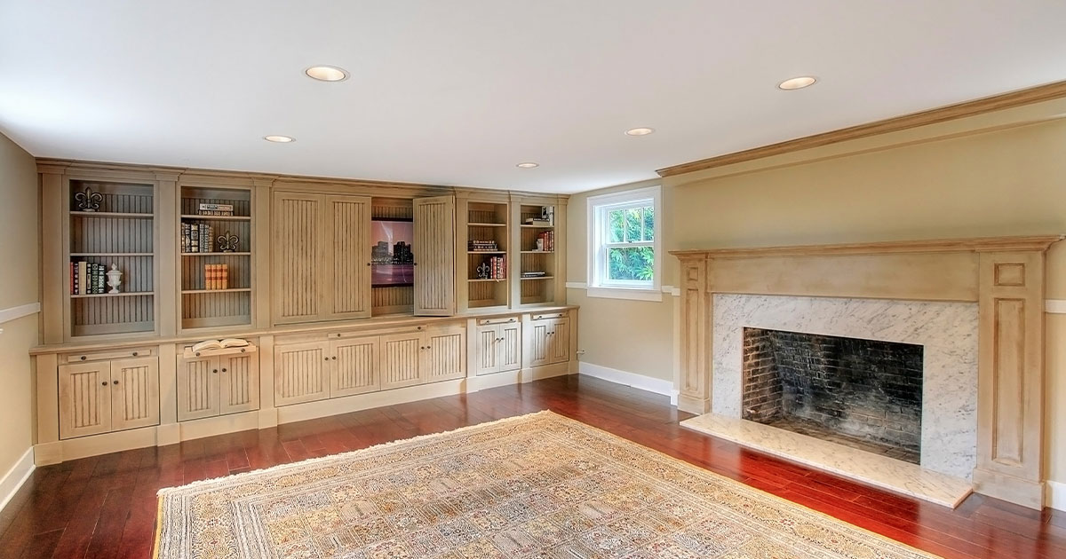 Add value to your home with a basement remodel with white cabinets and a fireplace
