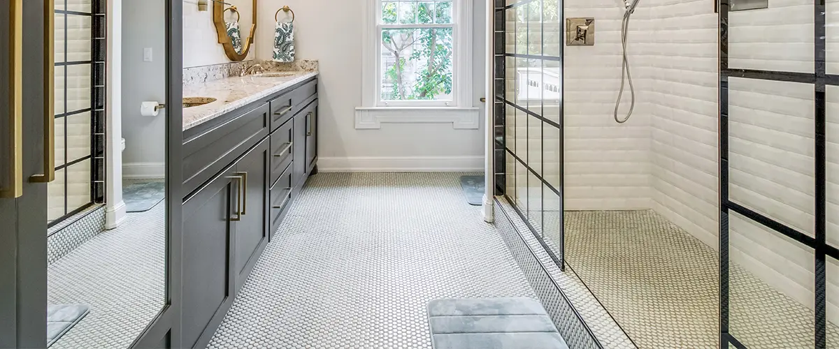 A tile floor with a dark blue vanity and walk-in shower
