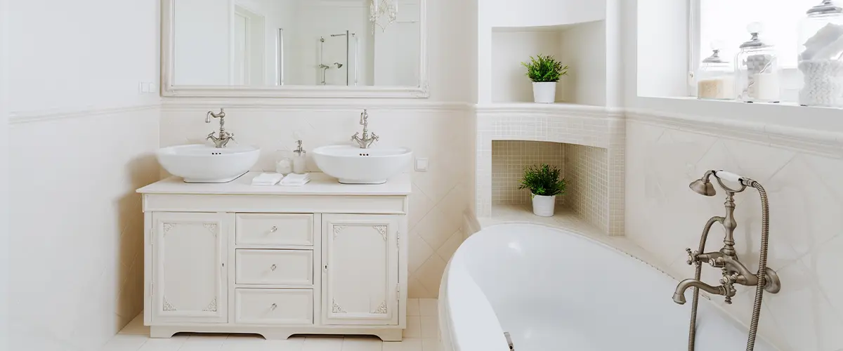 A tiled bathroom with a tub and simple vanity in a bathroom remodeling project