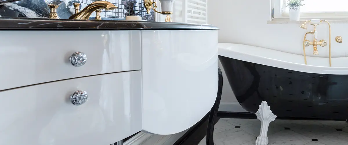 reflective drawers in a small white bathroom